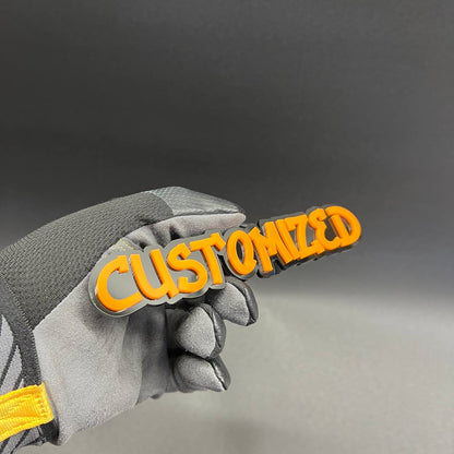 Orange and black custom graffiti car badge for vehicle exterior.