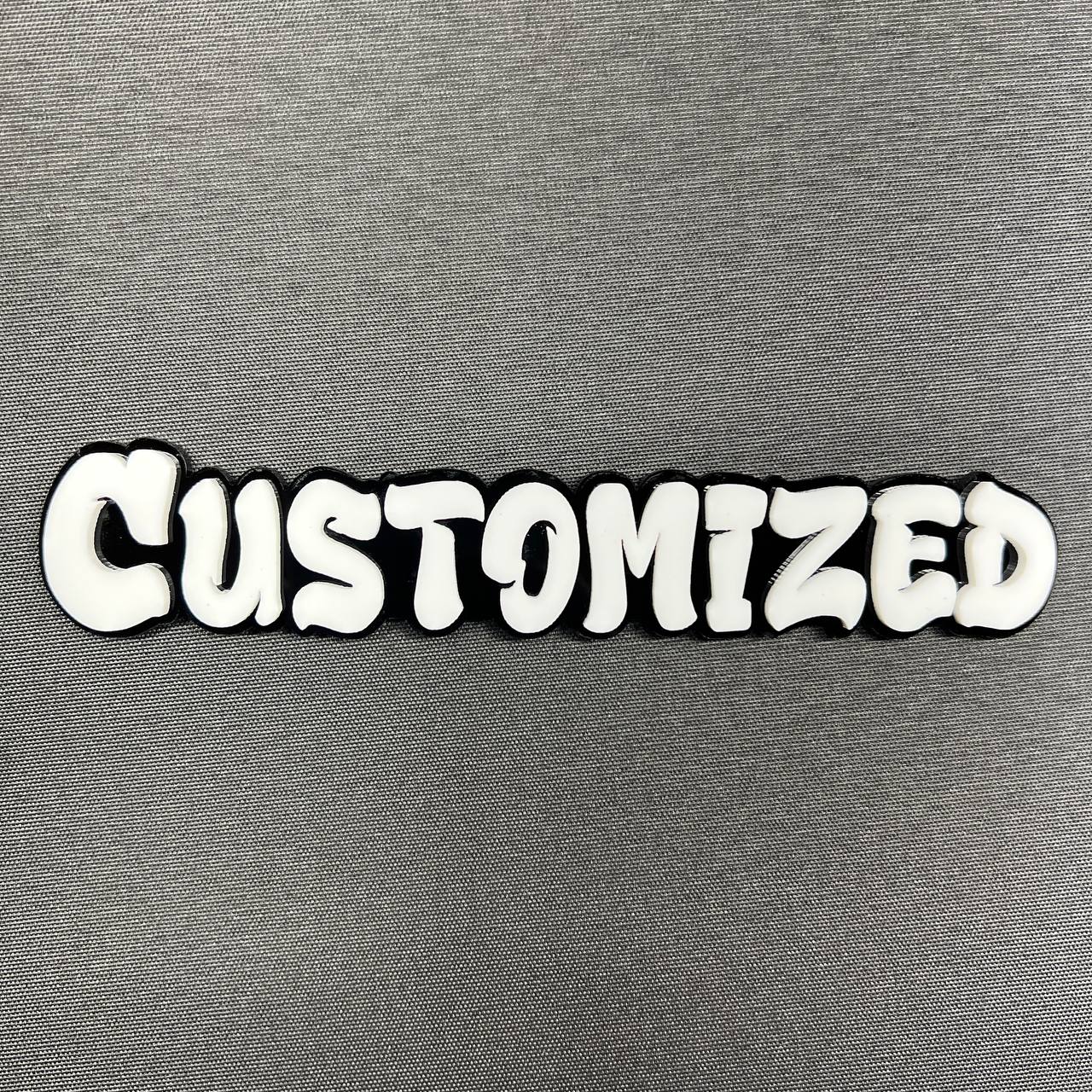 Custom graffiti font car badge in white letters with black outline
