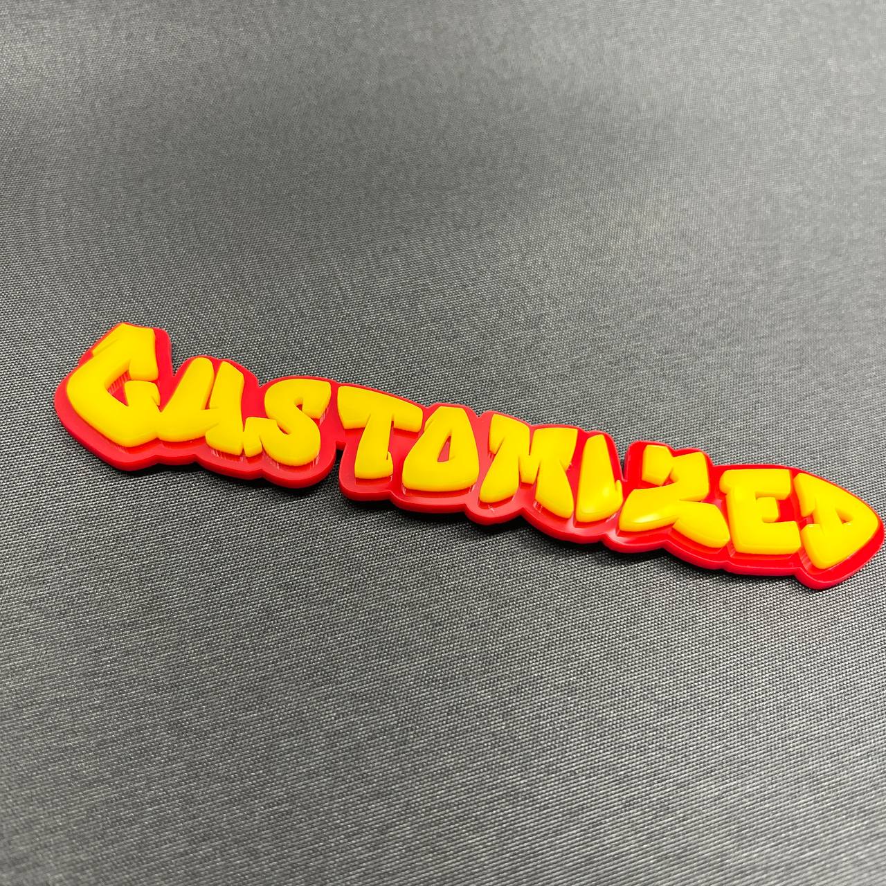 Graffiti style car emblem with personalized name lettering.