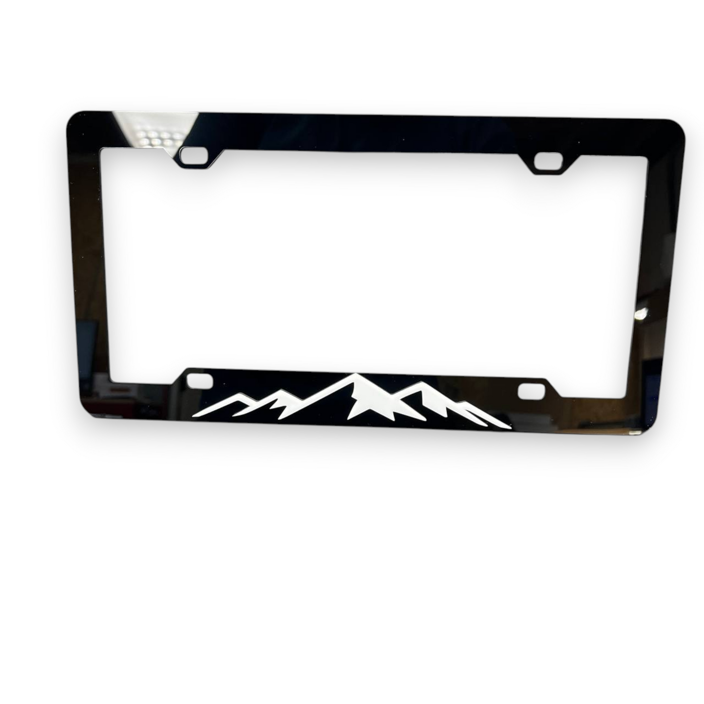 Rugged outdoor inspired mountain plate frame for pickup truck accessories