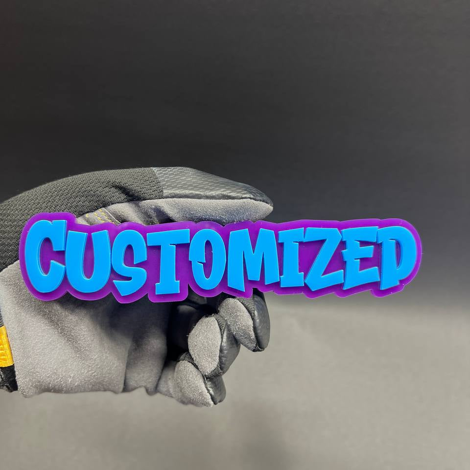 Custom graffiti text car badge with blue letters and purple backing