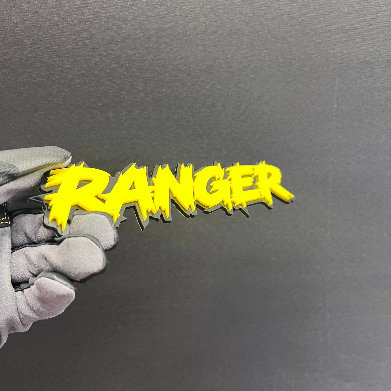 Ranger custom car badge with bold yellow lettering and black backing
