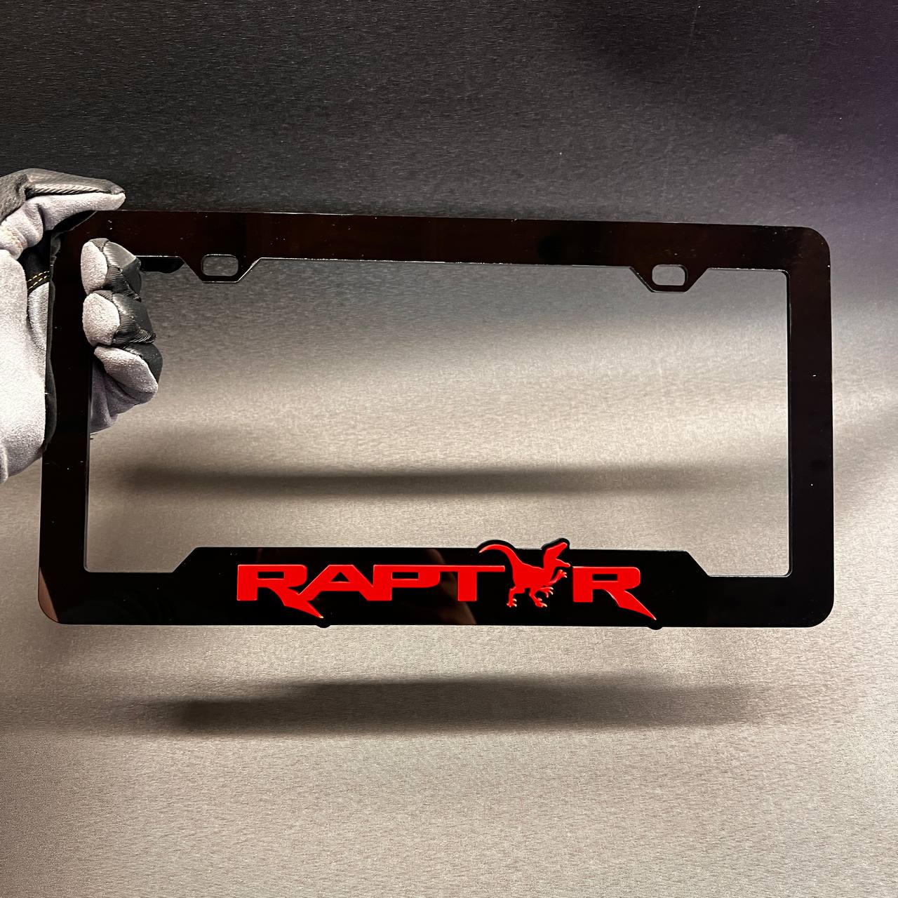 Red Raptor logo license plate frame designed for truck and SUV styling