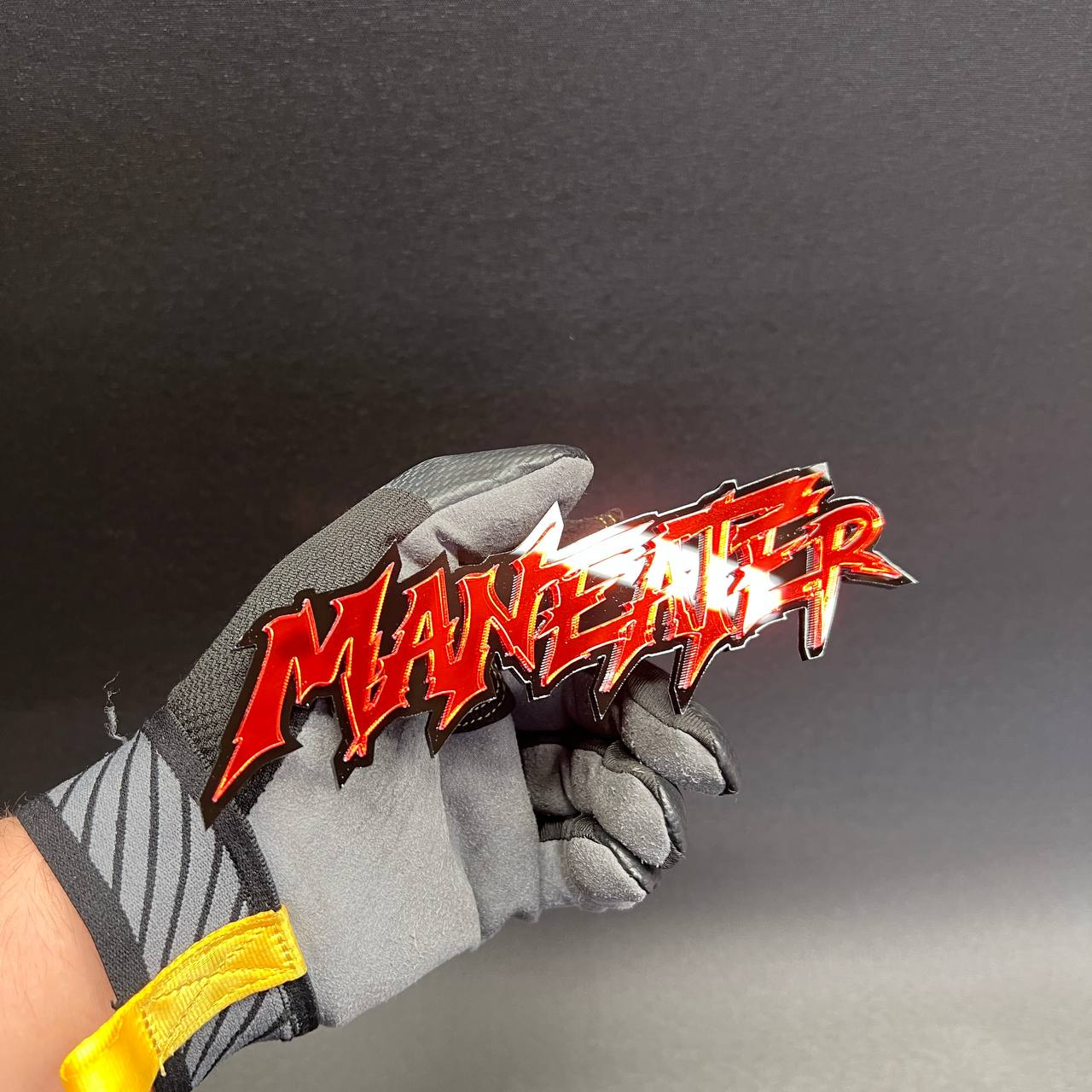 Red mirrored MANEATER text badge for custom automotive exterior modification