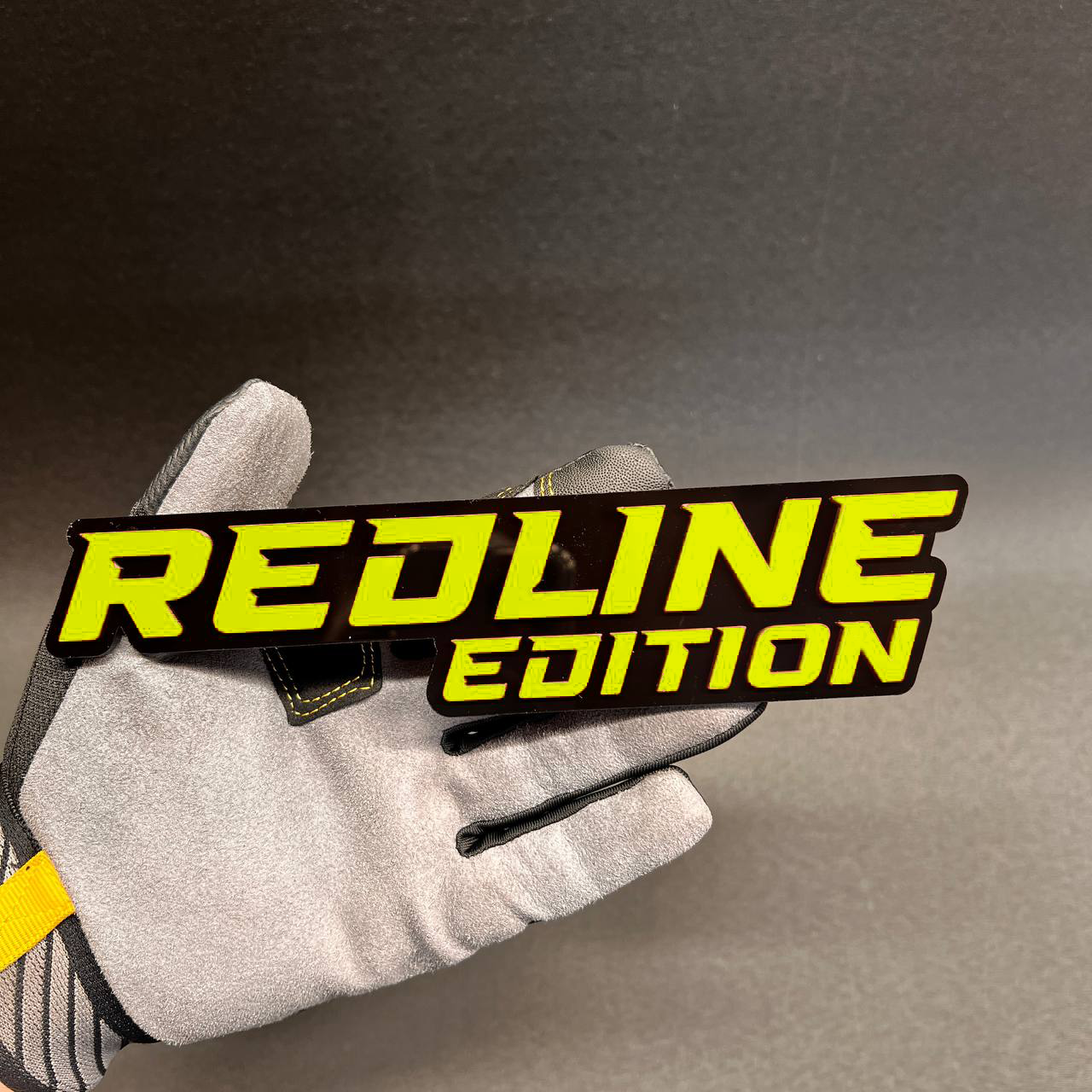 Red and black Redline Edition truck badge with performance style design