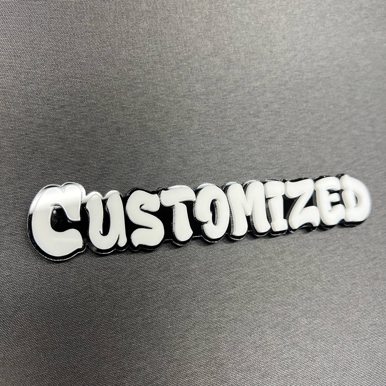 White and black customized graffiti badge for car exterior