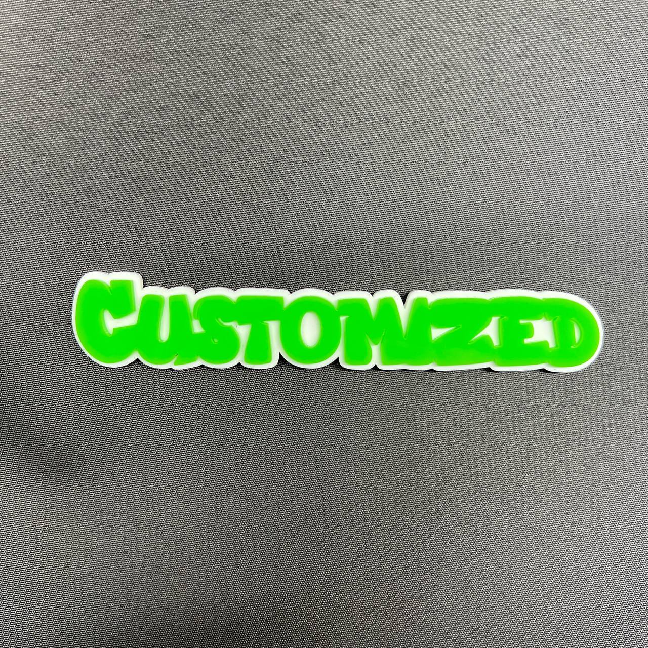 Custom green text car badge with white outline for exterior vehicle decoration