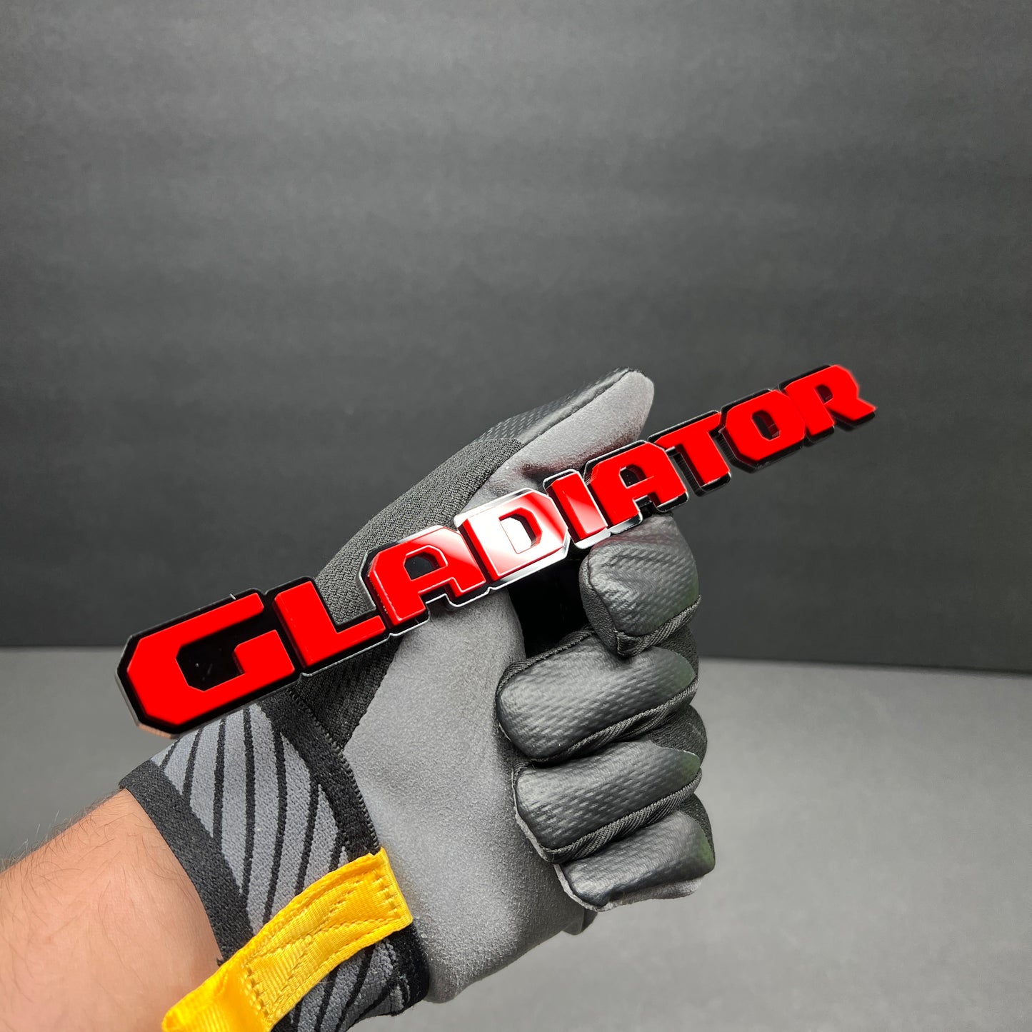 Acrylic GLADIATOR text emblem with black outline and gloss red finish