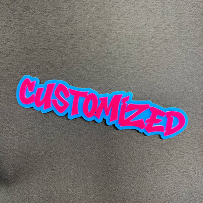 Pink and blue customized car emblem with graffiti style text
