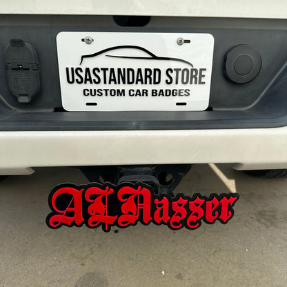 Custom word hitch cover with red lettering and black base for rear truck receiver