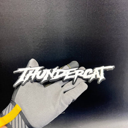 THUNDERCAT exterior text badge shown against a black background