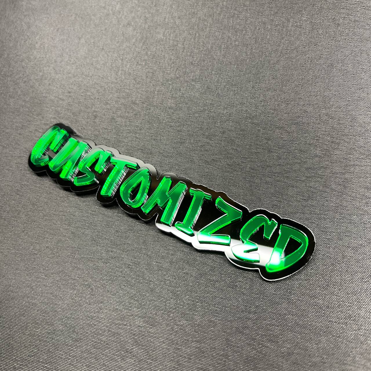 Green and black custom text car emblem with 3D layered design