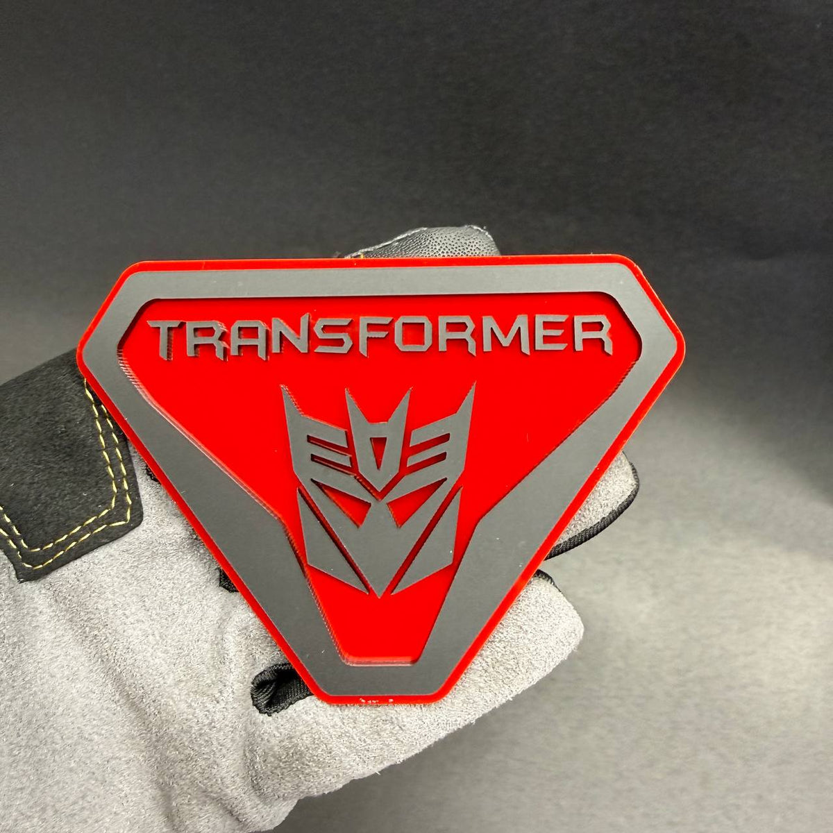 Decepticon Transformers car emblem featuring layered acrylic construction and geometric robot face design for Jeep Gladiator customization.