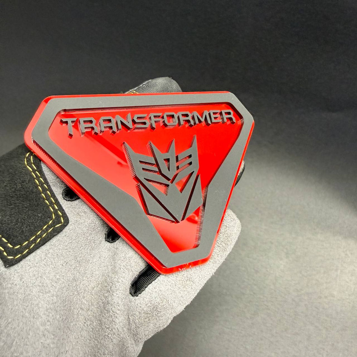 Custom Decepticon robot logo fender badge with contrasting silver details and red shield background for truck exterior accessories.