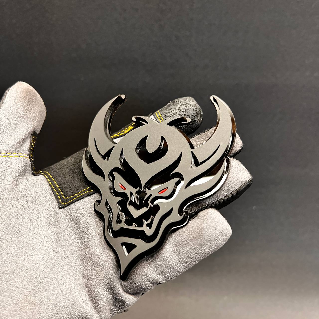 Demon Face car badge fender emblem in black and silver with red eye details