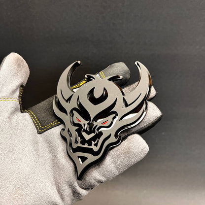 Demon Face car badge fender emblem in black and silver with red eye details
