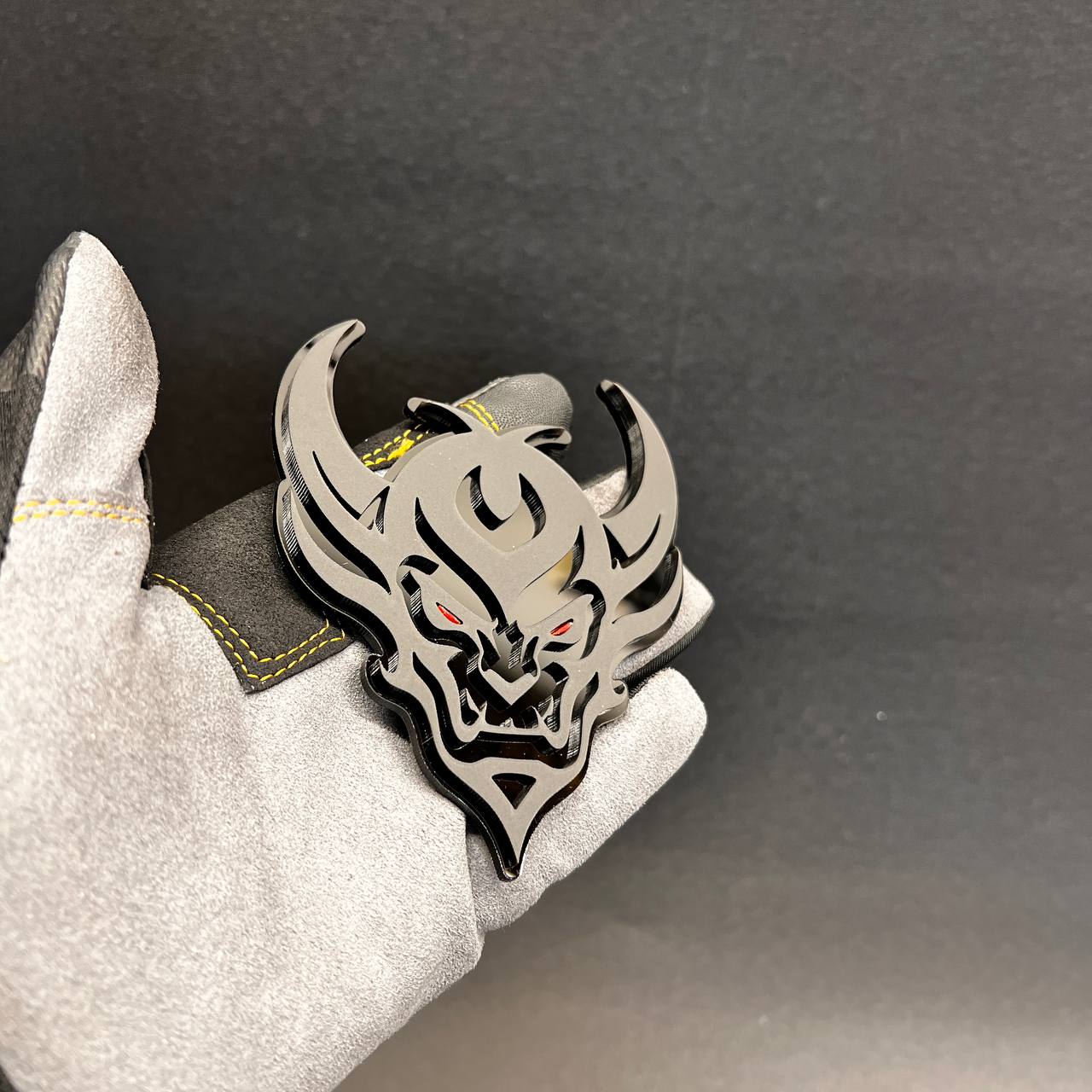 Demon Face exterior vehicle badge with black backing and silver top layer