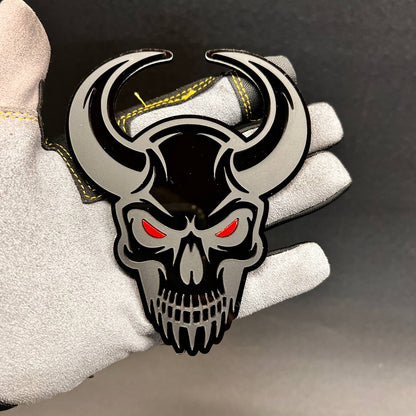 Demon Skull car badge with black and gray layered design and red eyes