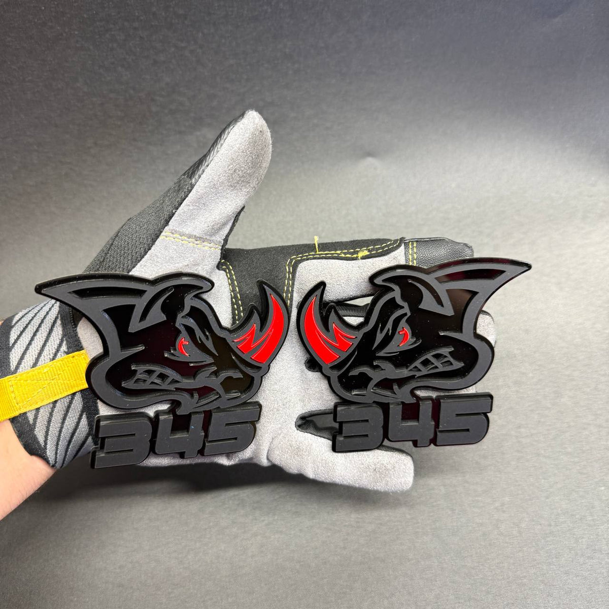 345 Rhino matte black automotive emblem with raised lettering and colored red accents, custom exterior badge for Dodge and Mopar enthusiasts.