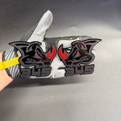 Custom 345 Rhino car emblem with matte black rhinoceros head, red horn and red eye accents, designed for Dodge Charger automotive styling.