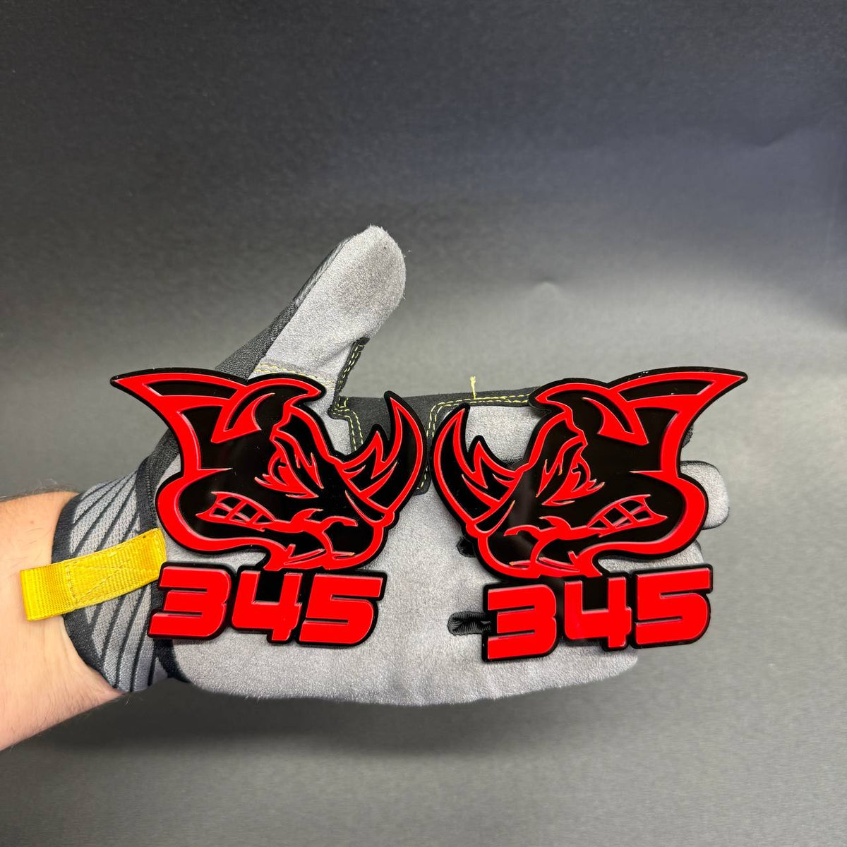 345 Rhino red and black car badge featuring aggressive rhinoceros head design for Dodge muscle car exterior styling.