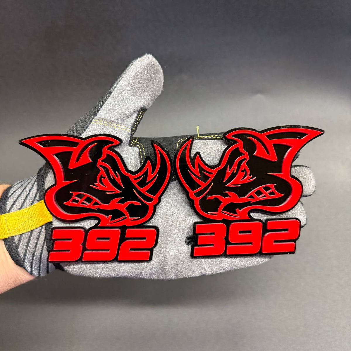 392 Rhino red and black car badge featuring aggressive rhinoceros head design, bold red 392 lettering and layered acrylic construction for Dodge muscle car styling