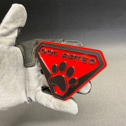 Decorative Dog Rated car emblem with raised black paw print and lettering, ideal for pet owners, dog lovers and personalized automotive accessories.
