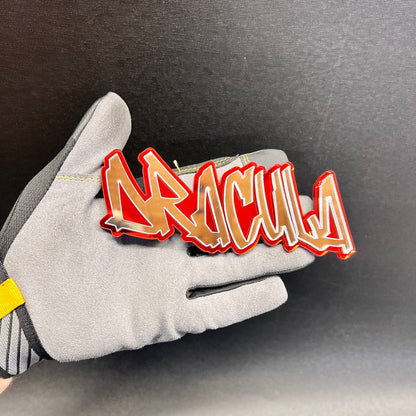 : Custom DRACULA car text badge featuring reflective letters and a red outline