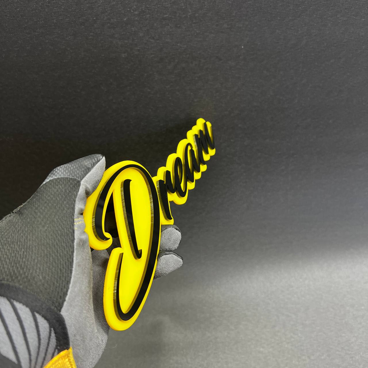 Personalized Dream script automotive emblem with black outline for RAM 1500 truck