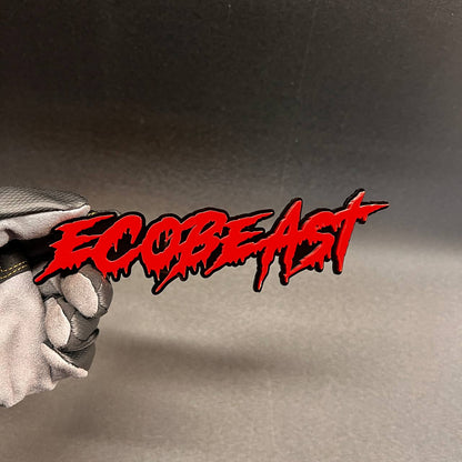 Red ECOBEAST text badge designed as an exterior car emblem with bold drip style