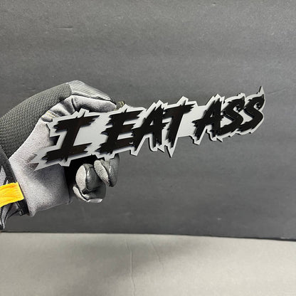 I EAT ASS acrylic text badge mounted style for truck grille and fender customization on Ford F150 performance builds