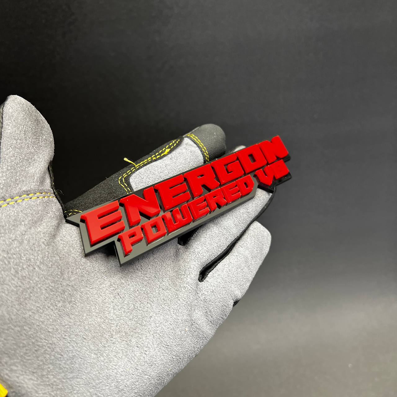 Custom text auto emblem with aggressive V8 powered design and gloss red finish.
