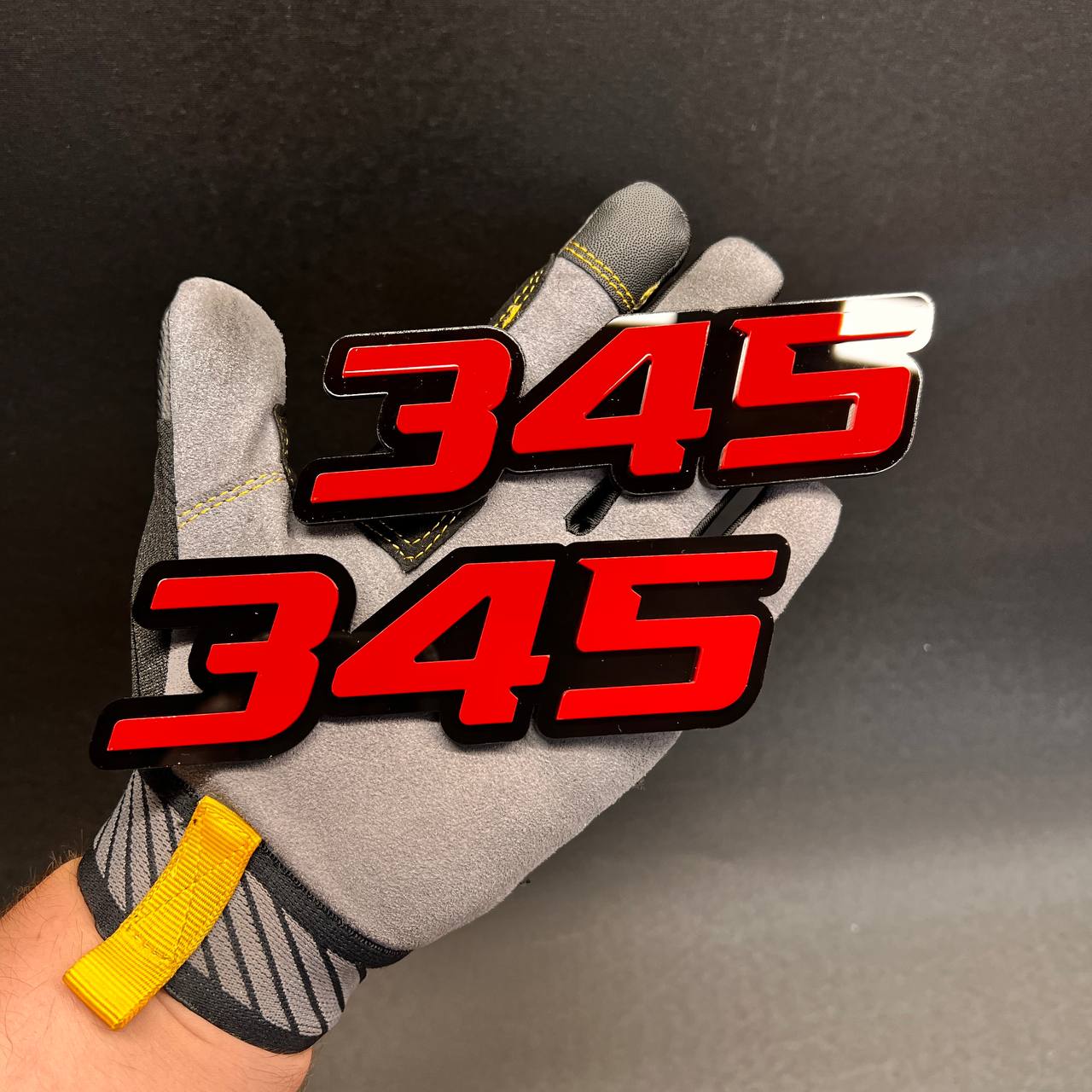 Red 345 vehicle badge with black outline for fender or tailgate