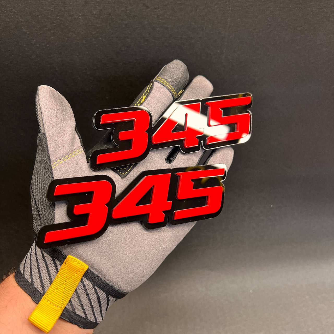Performance style 345 car badge with bold red numbers and black backing