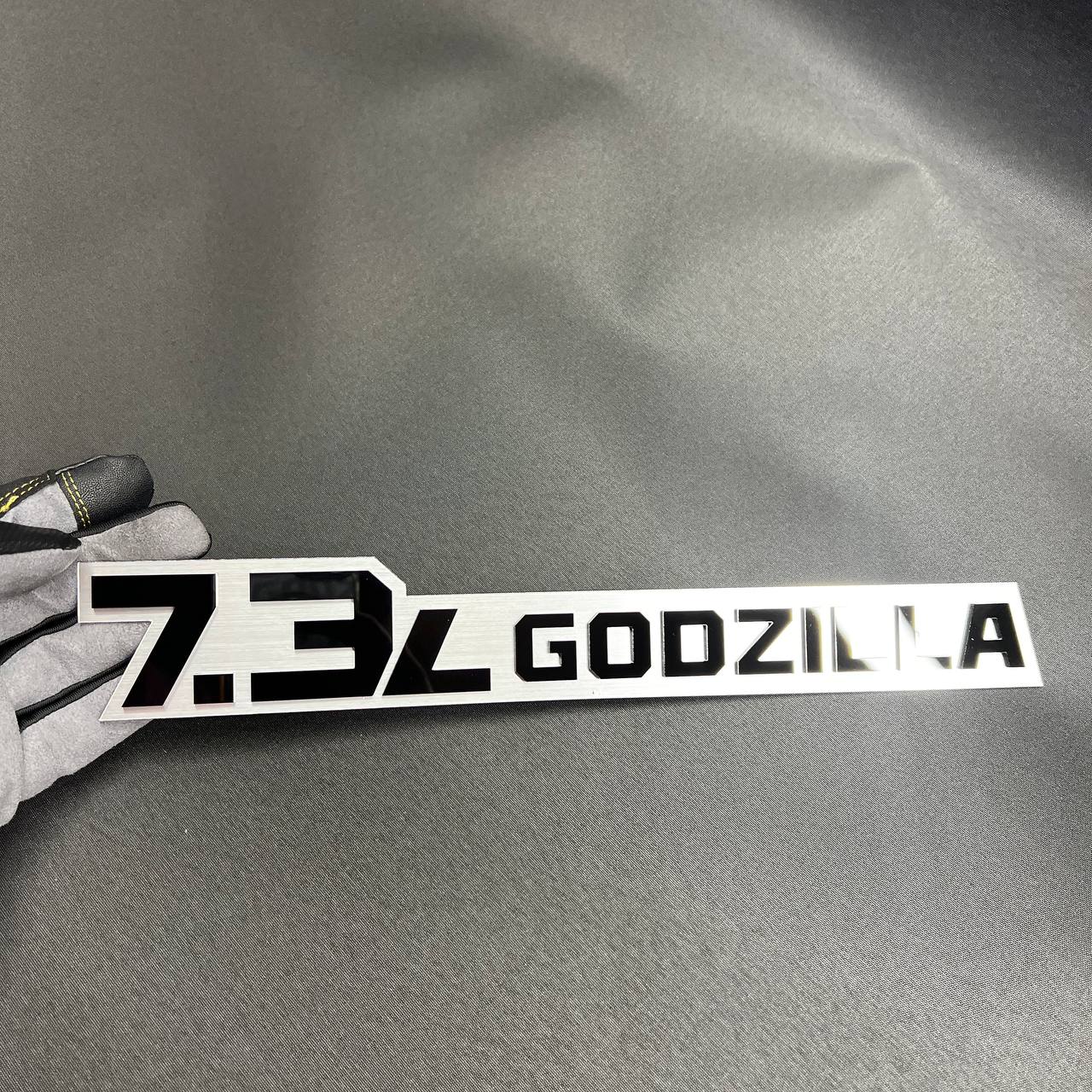 7.3L Godzilla truck decal emblem shown as a custom acrylic badge for Ford builds.
