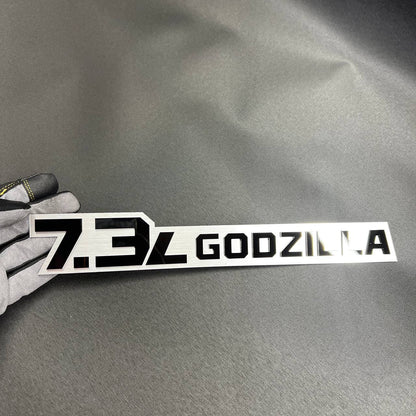 7.3L Godzilla truck decal emblem shown as a custom acrylic badge for Ford builds.