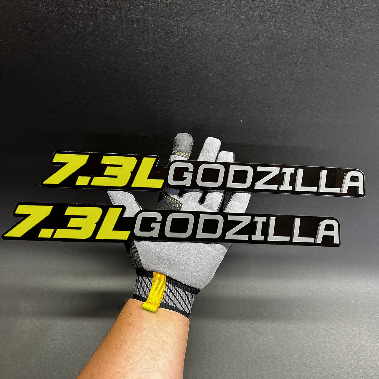 7.3L Godzilla matte black truck badge with clean performance engine design.