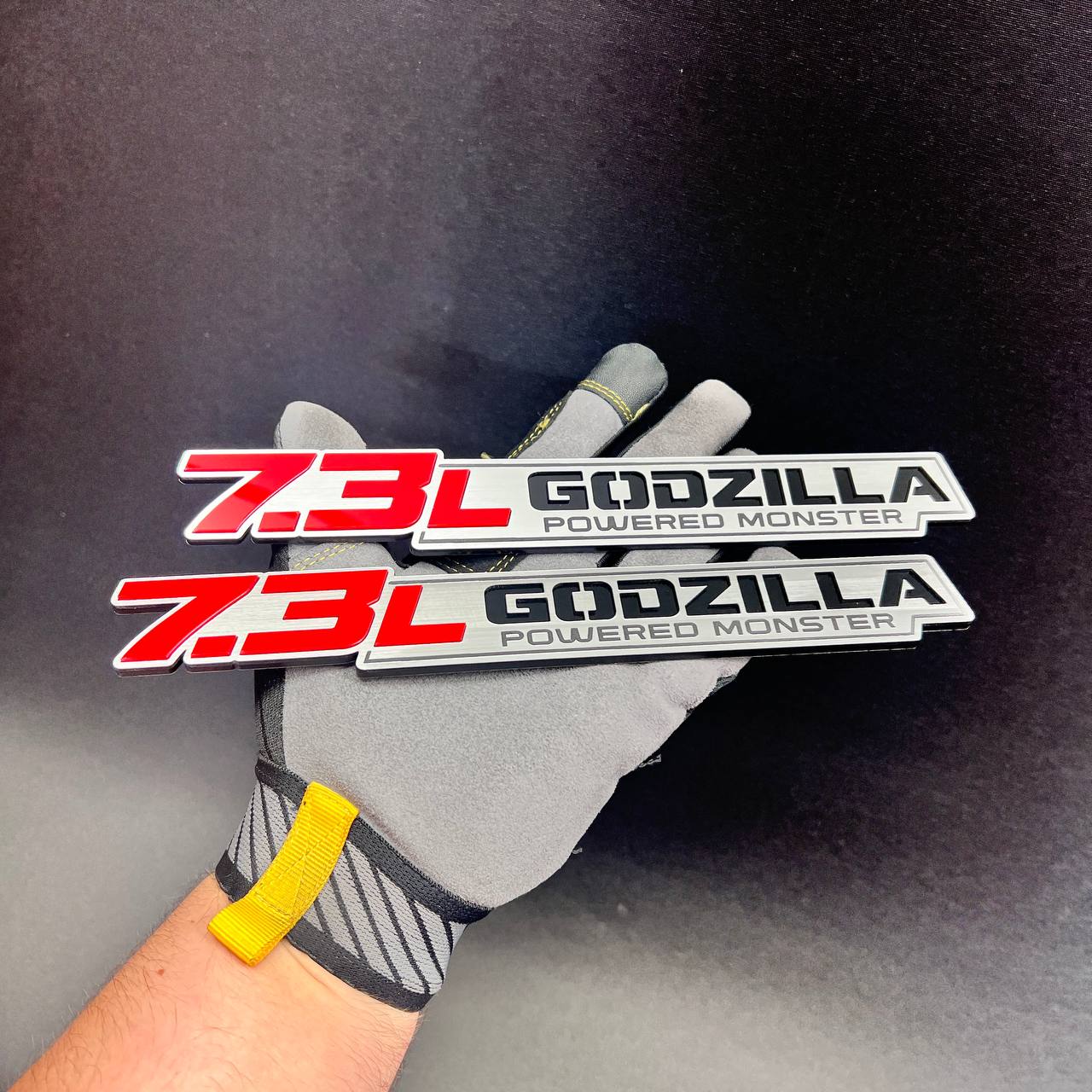 Brushed silver 7.3L Godzilla engine badge with red and black lettering