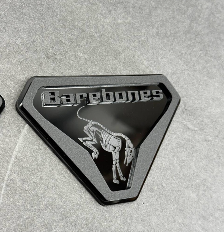 Custom layered acrylic Barebones skeleton badge designed for Ford Bronco vehicles