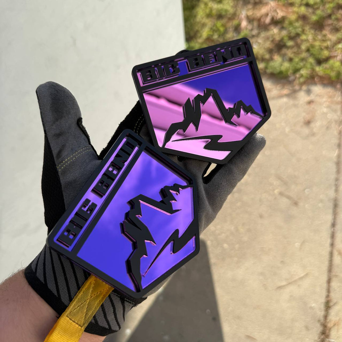 Ford Bronco Big Bend fender emblem featuring a glossy purple mirror backing and raised matte black mountain design.