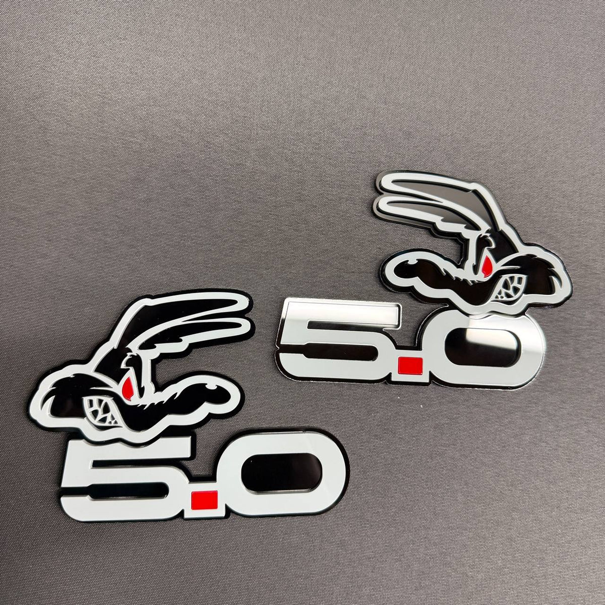 Mustang GT Coyote 5.0 gray red dot emblem featuring bold 5.0 lettering and stylized coyote head for exterior automotive styling.