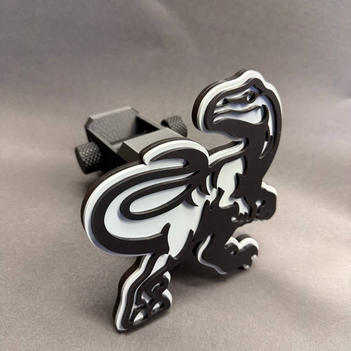 Black and white Raptor trailer hitch receiver cover for Ford F150 truck