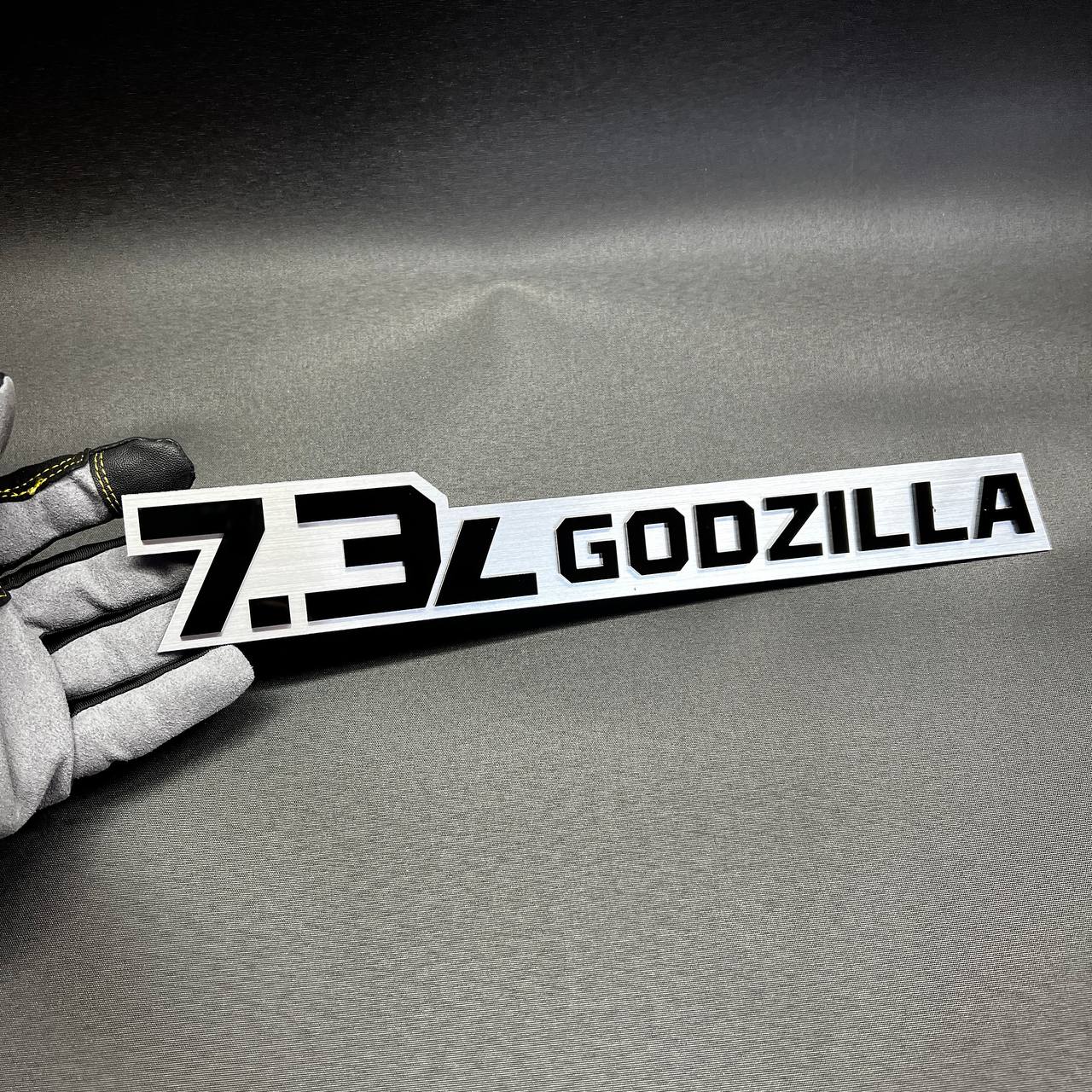 Ford Super Duty 7.3L Godzilla side badge with glossy black backing and bright pink top layer.