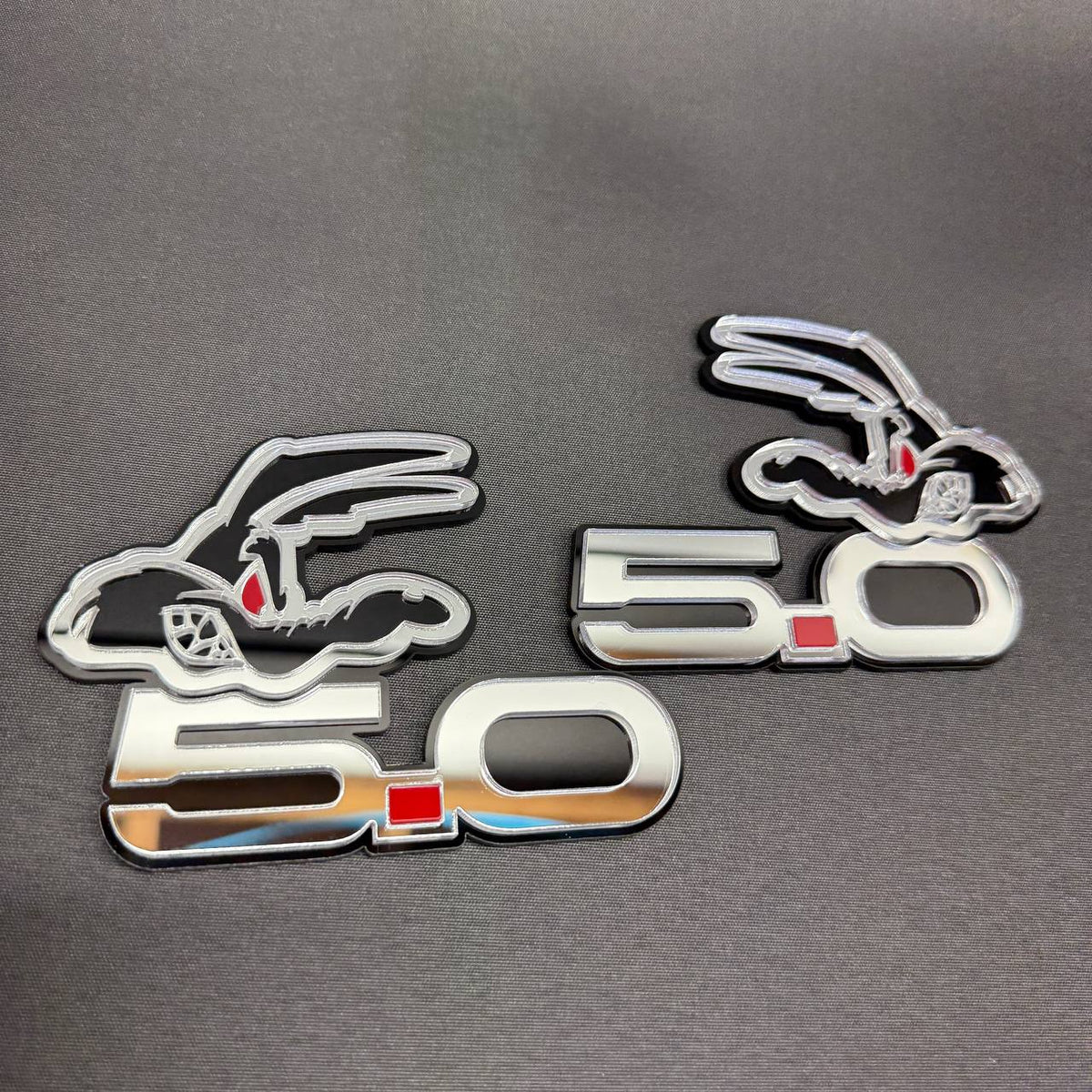 Coyote 5.0 mirror silver car badge with red eyes and detailed cartoon coyote design for Ford Mustang GT fender customization.