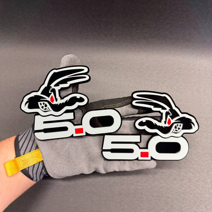 Laser-cut Coyote 5.0 gray fender emblem featuring black outline, red dot between 5 and 0 and layered automotive construction.