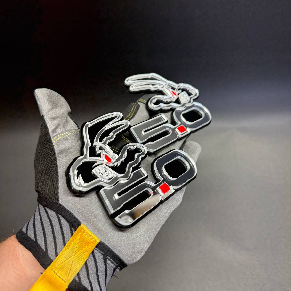 Custom Coyote 5.0 V8 fender emblem featuring reflective mirror silver acrylic, black outlines and red accents for Ford Mustang.