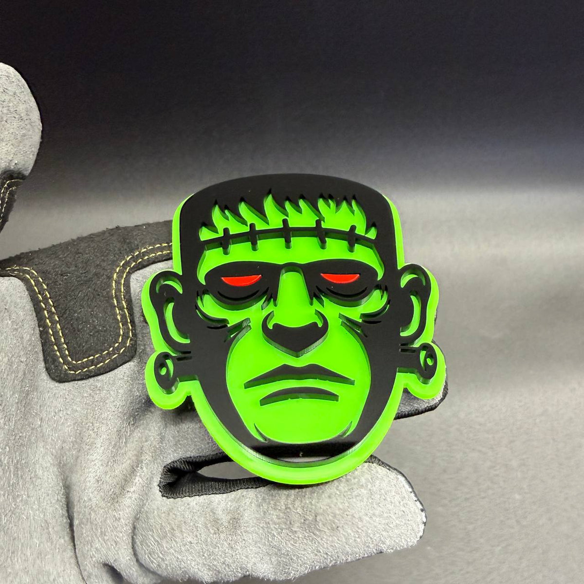 Halloween Frankenstein monster automotive badge with green black design and red eyes for cars and trucks