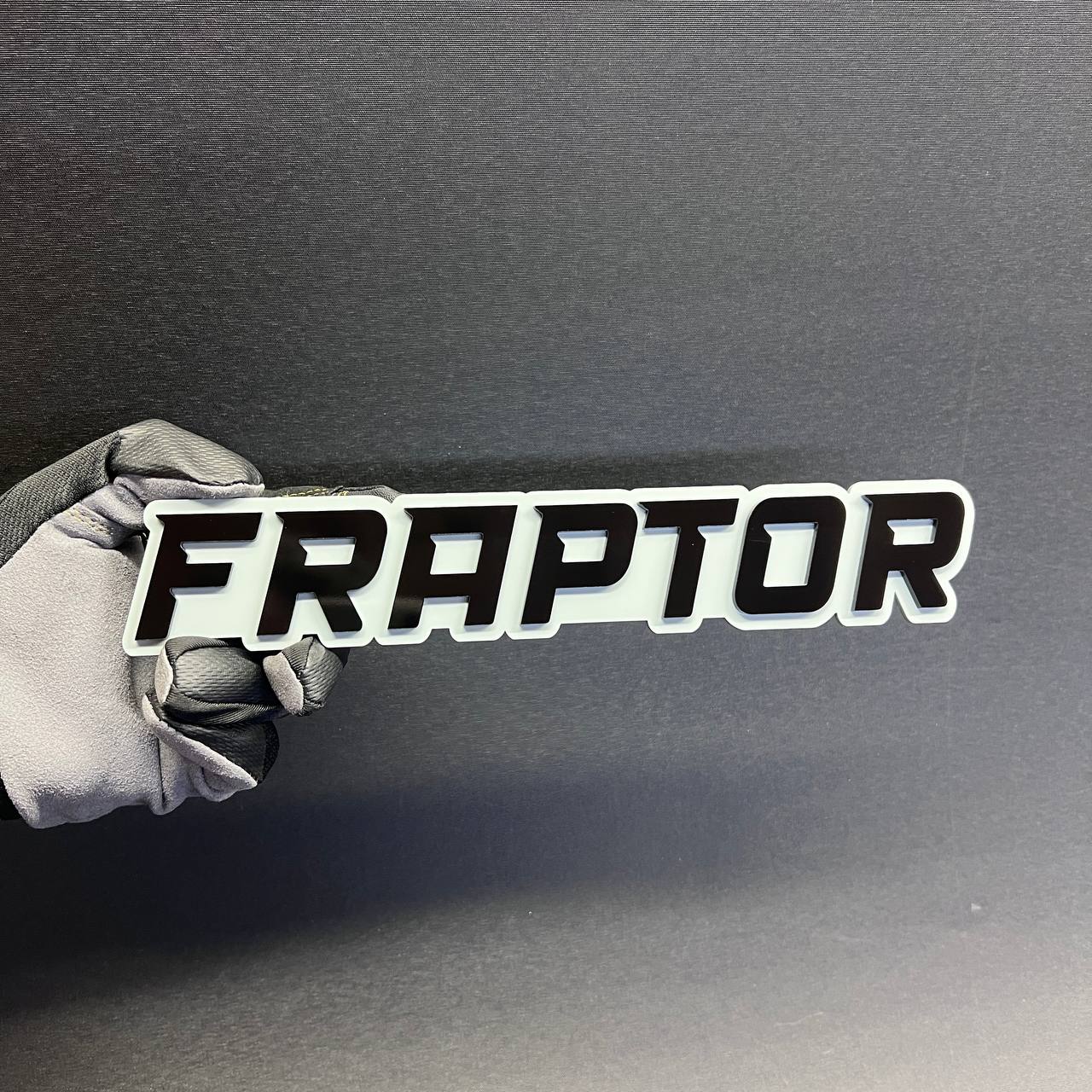 Black and white FRAPTOR custom truck badge with bold racing style lettering.