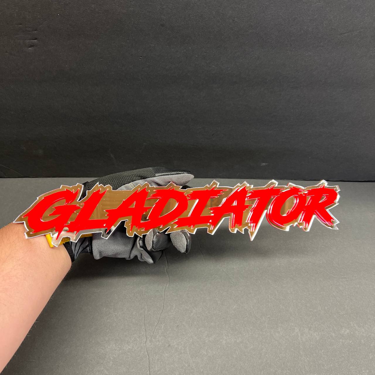Custom acrylic GLADIATOR emblem for Jeep Gladiator offroad accessory styling.