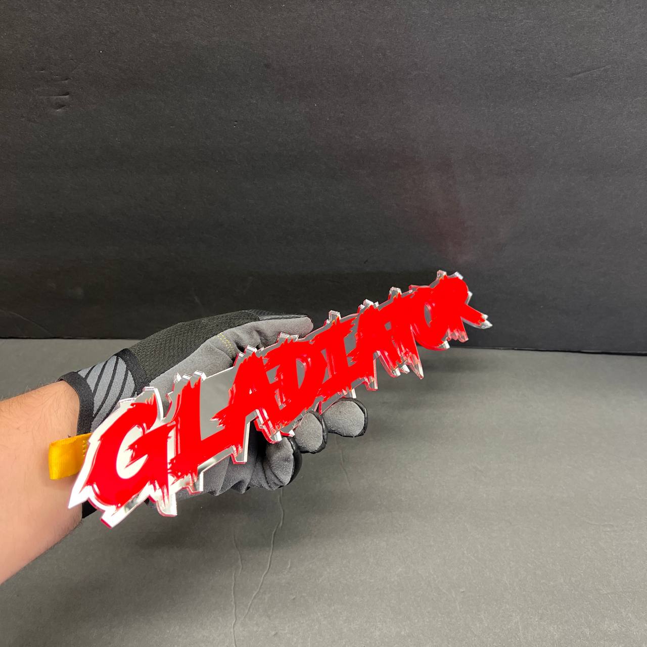 GLADIATOR text badge in red and white acrylic for truck tailgate or fender.